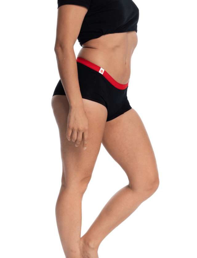 Culotte menstruelle de la marque Mme L’ovary. Modèle Nighty noir avec élastique rouge. Flux abondant. Tailles du XXS au XXL. A retrouver dans les boutiques menstruelles Rañute, en Suisse.